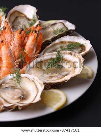 oyster and shrimp on black background