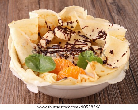 delicious crepe with banana, chocolate and orange