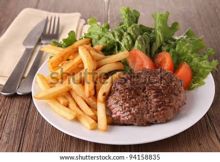 grilled steak, french fries and vegetables