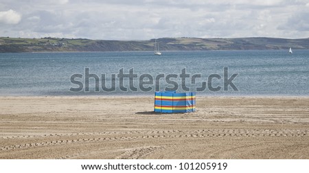 red, yellow and blue striped wind break on the beach