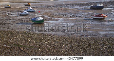 at low tide, the boats have been stranded, waiting for the tide to return