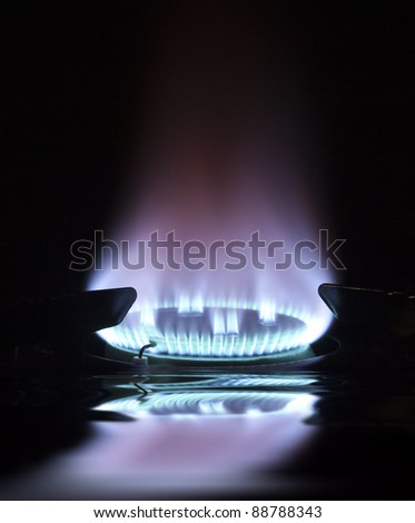 blue flame on gas hob with reflection