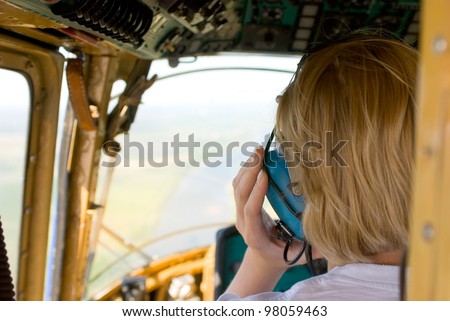 blonde woman pilot in helicopter