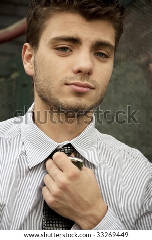 Portrait of young handsome man with tie and cell phone