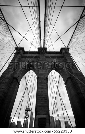 Black and white upward image of Brooklyn Bridge in New York