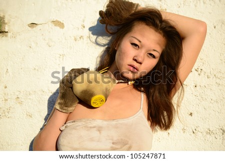 dirty long haired asian woman with dusty mask and gloves