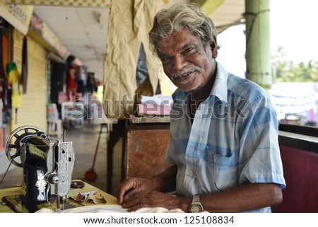 BERUWALA, SRI LANKA - NOVEMBER 13:  man sewing in a small tailor shop, industrial sewing machine on November 13, 2012 in Beruwala, Sri Lanka. Sri Lankan private sewing industry.