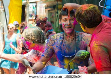 ARAMBOL, GOA - MARCH 27: Unidentified people celebrate Holi festival in Arambol Main Street, GOA, India on March 27, 2013. It\'s a religious spring holiday and also known as Festival of Colours.