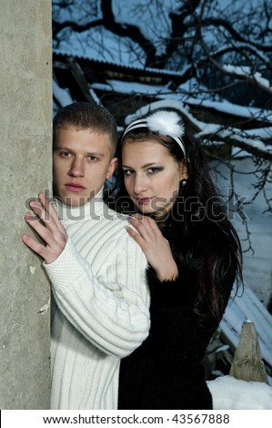 Couple standing near a wall, winter weather man