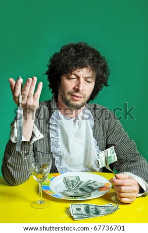 Man With money on the dish inside of food.