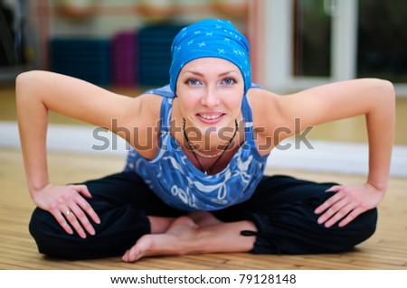 Young woman exercises at yoga class
