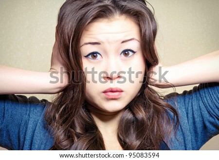 Cute girl pressing her head confused and surprised