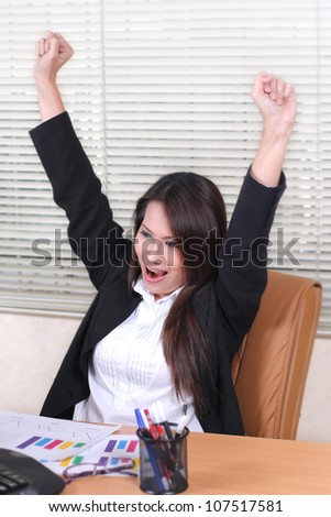 pretty business woman hands raised with stretching in the office