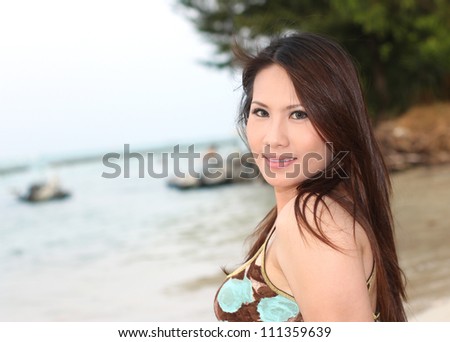 beautiful woman on the beach with smile expression