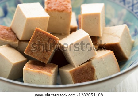 Cubes of smoked tofu on a dish close up