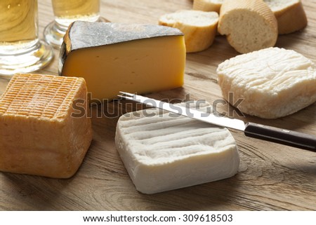 Traditional Belgian cheese board as dessert with beer and bread