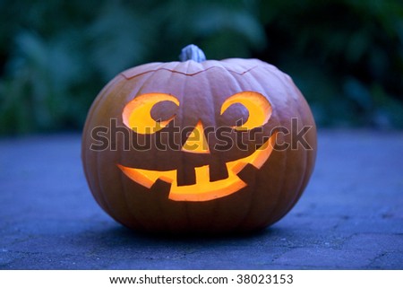 Illuminated Halloween pumpkin in the garden