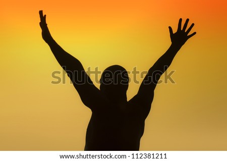 Silhouette of a man with outstretched arms on a yellow background