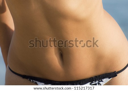 Part of the body of a woman enjoying summer at the beach