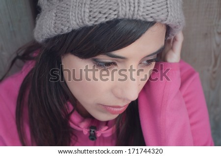 Portrait of young woman looking down and lonely
