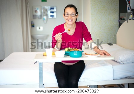 A portrait photo of woman patient eating food in hospital.