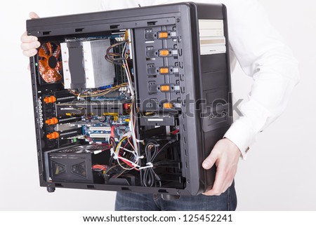 computer support engineer holding an office Computer for upgrading it. Studio shot on a white background