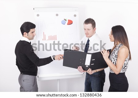 three business people in front of a flipchart during a presentation and business meeting.studio shot on a white background.
