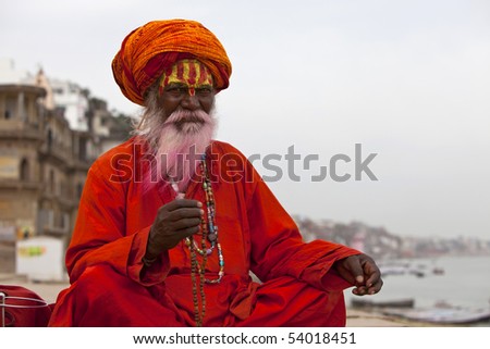 Sadhu at the ghats in Varanasi, India. With a pink beard from the traditional holi festival.
