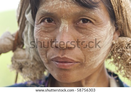 KALAW, BURMA- MAR 17:portrait of a burmese woman with thanaka powdered face who works in the field MAR 17, 2010 in Kalaw, Burma (Myanmar).