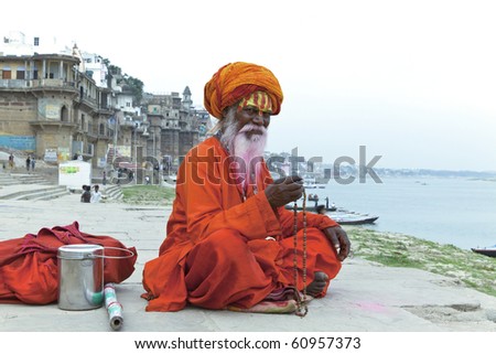 Sadhu at the ghats in Varanasi India With a pink beard from the traditional holi festival. Sadhu at the ghats in Varanasi India With a pink beard from the traditional holi festival.