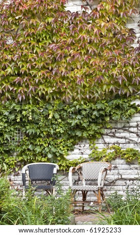 comfortable place to sit with a view to the backyard.  chairs in the garden on a day in autumn.