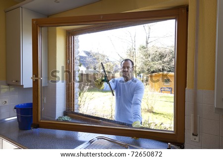 man cleaning a window at home. spring cleaning.