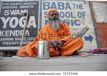 VARANASI, INDIA- MAR 01: indian sadhu at the gate in Varanasi MAR 01, 2010 in Varanasi, India. Sadhus are ascetic, practitioner of yoga and/or wandering monks.