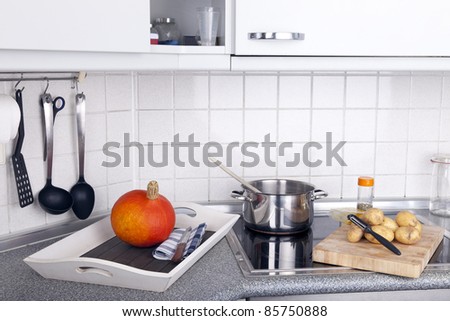 studio-shot of preparing lunch for the family. cooking pumpkin soup in a modern kitchen.