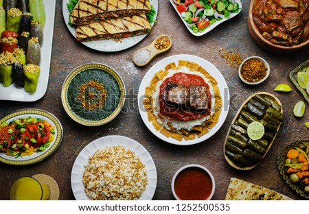 Arabic cuisine; Middle Eastern traditional lunch. It's also Ramadan 'Iftar'. The meal eaten by Muslims after sunset during Ramadan. Assorted of Egyptian oriental dishes. Top view with close up.
