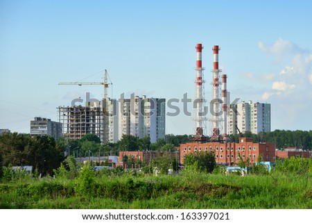 Construction of multi-level residential buildings next to the industrial zone near Moscow