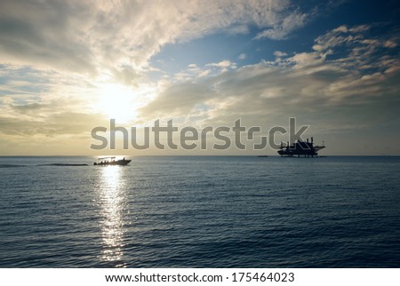 Oil platform in the sea at sunset.