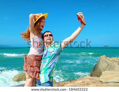 Happy tourist couple in Vietnam taking a photo with a digital compact camera