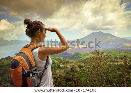 Woman traveler looking at Batur volcano Indonesia Woman traveler looking at Batur volcano Indonesia