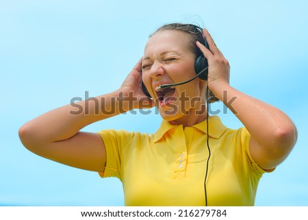 Beautiful call centre operator or client services office trying to explain something to a client over the microphone of her headset