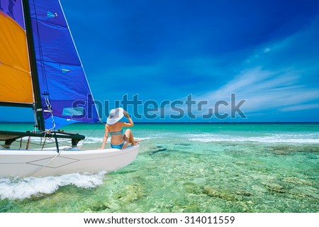 Young woman traveling by boat among the islands. Travel to Asia, happiness emotion, summer holiday concept