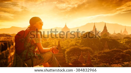 Young traveller enjoying a looking at sunset on Bagan, Myanmar Asia. Panoramic view.\
Traveling along Asia, active lifestyle concept.