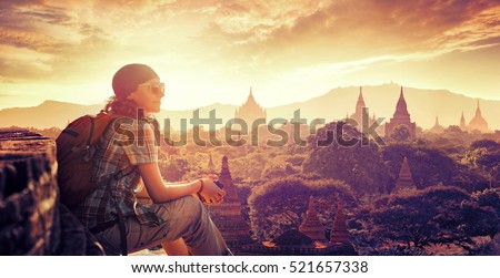 Young backpacker enjoying a looking at sunset on Bagan, Myanmar Asia. Traveling along Asia, active lifestyle concept