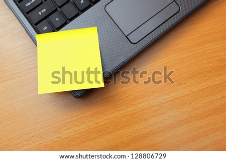 Blank orange post it notes on a laptop PC