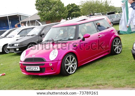 stock photo PETERBOROUGH ENGLAND MAY 24 Pink BMW Mini One on May