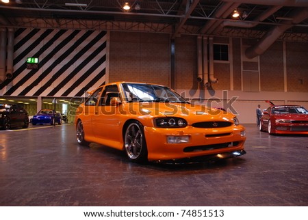 stock photo BIRMINGHAM ENGLAND JULY 5 Orange Ford Escort Cosworth on
