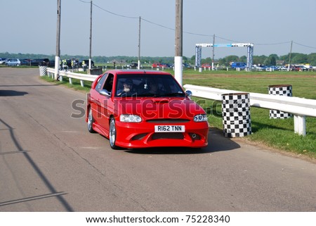 stock photo NORTHANTS ENGLAND MAY 11 Red Ford Escort on Display at