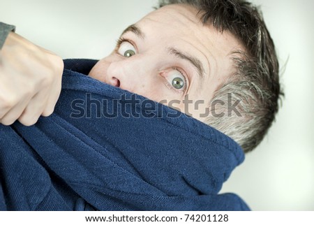 Close-up of a man wearing a housecoat being yanked off camera.