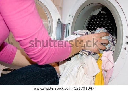 Woman filling Washing Machine