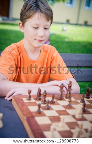 Boy play Chess with Concentration